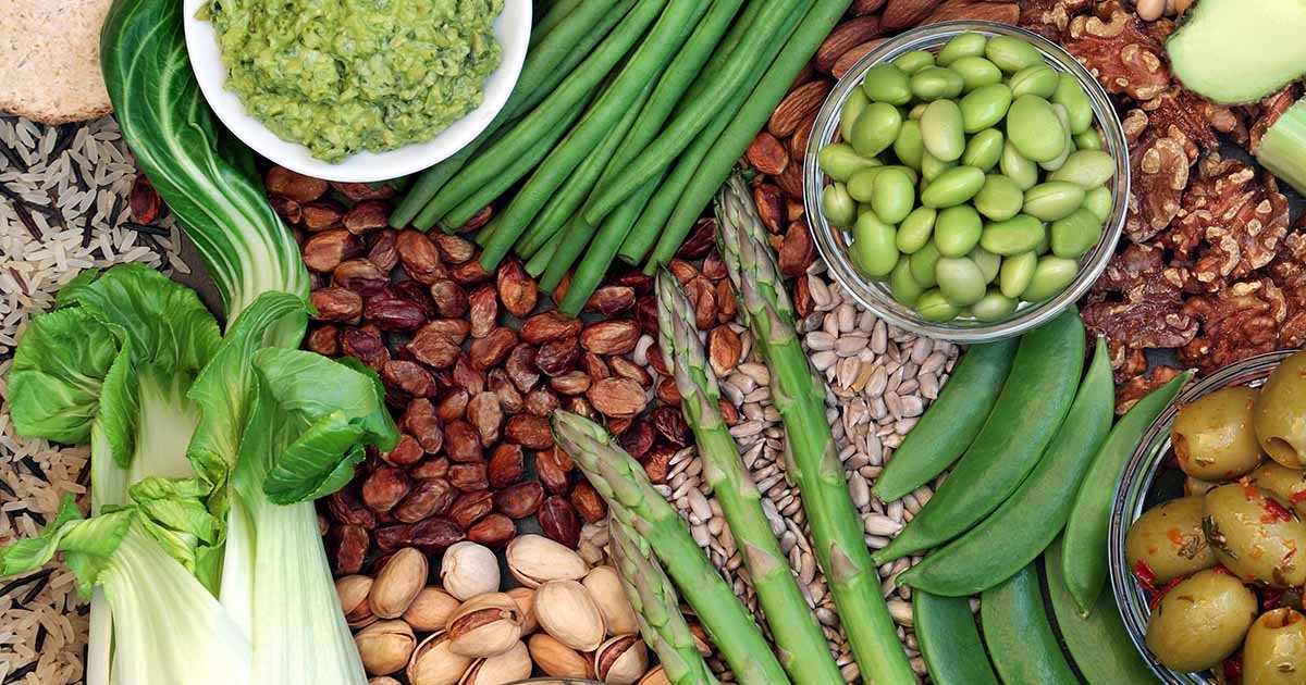 Scoop of plant-based protein with greens and fruits